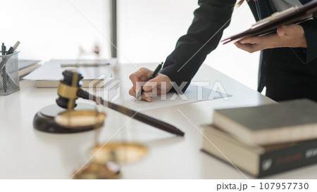 Law and justice concept, Female lawyer is writing contract and agreement while working in law firm Law and justice concept, Female lawyer is writing contract and agreement while working in law firm 107957730