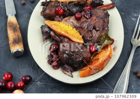 Baked chicken legs with berries in wine sauce. Baked chicken legs with berries in wine sauce. 107962309