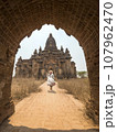 Young Tourist Woman Running in White Dress to Old Traditional Burmese Temple. Travel Adventure 107962470