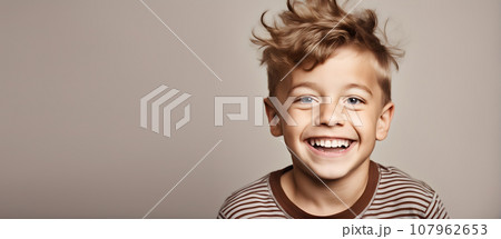 Excited smiling boy on solid color background Excited smiling boy on solid color background 107962653