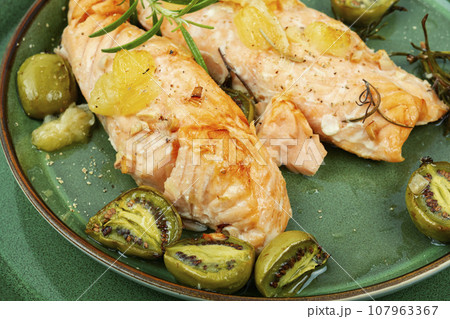 Baked salmon fillets with mini kiwi. Baked salmon fillets with mini kiwi. 107963367
