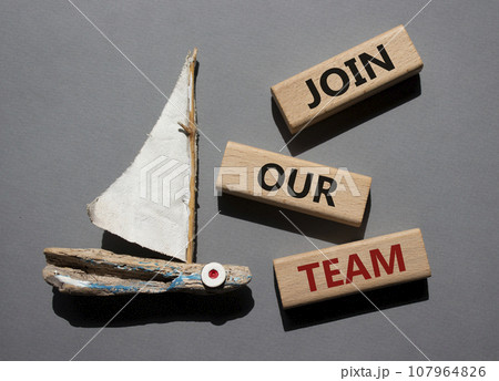 Join our team symbol. Wooden blocks with words Join our team. Beautiful grey background with boat. Business and Join our team concept. Copy space. Join our team symbol. Wooden blocks with words Join our team. Beautiful grey background with boat. Business and Join our team concept. Copy space. 107964826