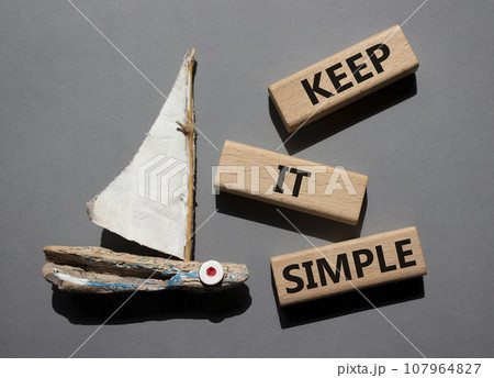 Keep it Simple symbol. Concept words Keep it Simple on wooden blocks. Beautiful grey background with boat. Business and Keep it Simple concept. Copy space. Keep it Simple symbol. Concept words Keep it Simple on wooden blocks. Beautiful grey background with boat. Business and Keep it Simple concept. Copy space. 107964827