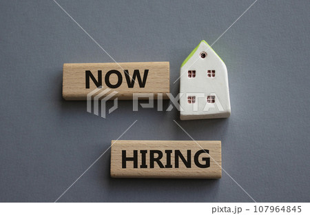 Now Hiring symbol. Concept word Now Hiring on wooden blocks. Beautiful grey background. Business and Now Hiring concept. Copy space Now Hiring symbol. Concept word Now Hiring on wooden blocks. Beautiful grey background. Business and Now Hiring concept. Copy space 107964845