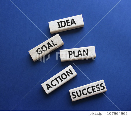 Idea Goal Plan Action Success symbol. Concept words Idea Goal Plan Action Success on wooden blocks. Beautiful deep blue background. Business concept. Copy space. Idea Goal Plan Action Success symbol. Concept words Idea Goal Plan Action Success on wooden blocks. Beautiful deep blue background. Business concept. Copy space. 107964962