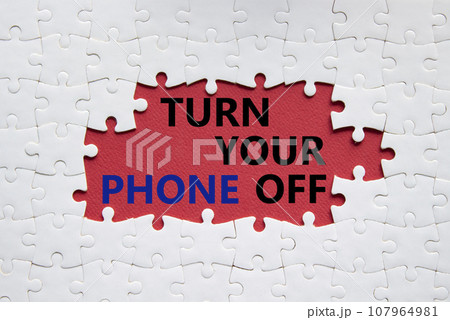 Turn Your Phone off symbol. White puzzle with words Turn Your Phone off. Beautiful red background. Business concept. Copy space. Turn Your Phone off symbol. White puzzle with words Turn Your Phone off. Beautiful red background. Business concept. Copy space. 107964981