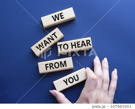 We want to hear from you symbol. Wooden blocks with words We want to hear from you. Beautiful deep blue background. Businessman hand. Business and We want to hear from you. Copy space. 107965001