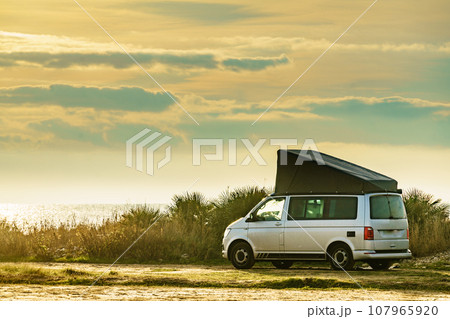 Van with roof top tent camping on nature 107965920