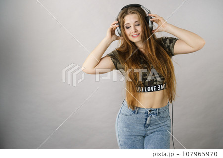 Teen women wearing headphones Teen women wearing headphones 107965970