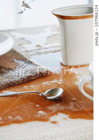 table with a puddle of coffee spilled accidentally table with a puddle of coffee spilled accidentally 107966134