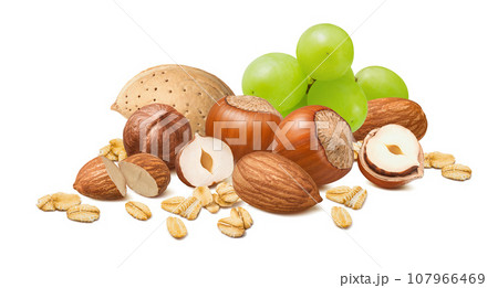 Hazelnuts and almonds in shell, green grapes and rolled oats isolated on white background 107966469