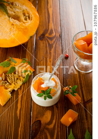 Homemade yogurt with pieces of pumpkin marmalade. 107967886