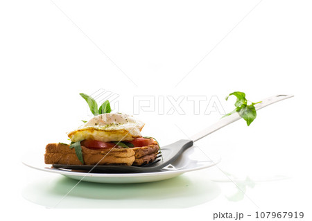 Prepared toast sandwich with fried egg with spices and herbs. 107967919