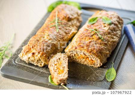 Cooked minced meatloaf with vegetable filling inside. Cooked minced meatloaf with vegetable filling inside. 107967922