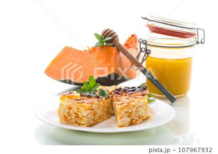 Cooked cottage cheese casserole with pieces of pumpkin inside. Cooked cottage cheese casserole with pieces of pumpkin inside. 107967932