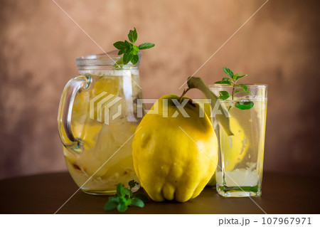 Prepared compote from ripe natural autumn quince, in a glass glass and decanter . 107967971