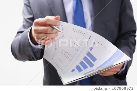 Hand of businessman in suit filling and signing 107969972