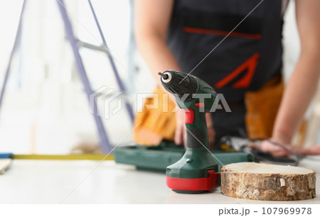 Arms of worker using electric drill Arms of worker using electric drill 107969978