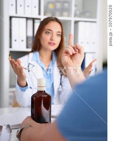 Alcoholic hold in arm empty bottle showing fuck 107970020