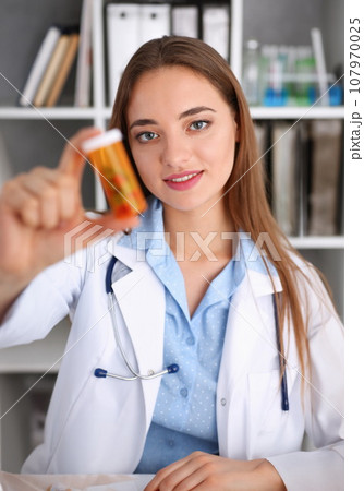 Beautiful smiling female doctor hold in arms Beautiful smiling female doctor hold in arms 107970025