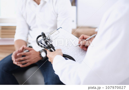 Male doctor hand hold silver pen and Male doctor hand hold silver pen and 107970027
