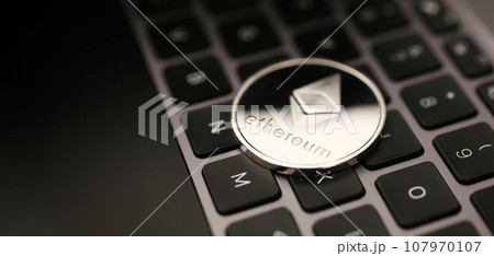 Coin crypto currency bitcoin lies on the keyboard 107970107