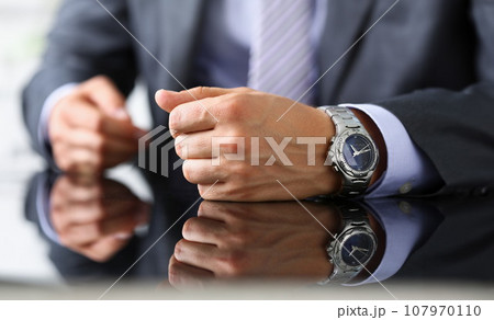 Man in suit and tie check out time at 107970110