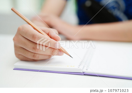 Asian teenage student write homework, study lesson for exam online learning education. 107971023