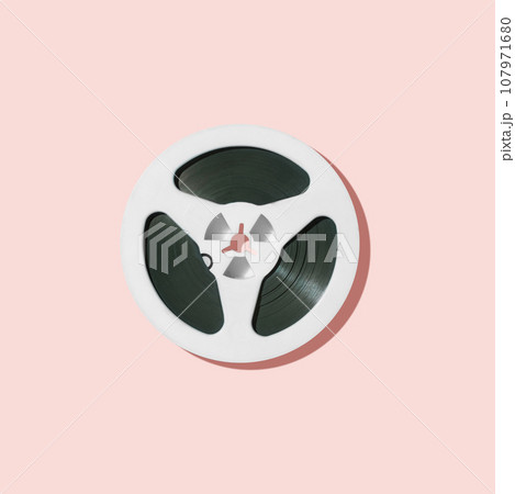 White reel for tape recorder isolated on pink background. White reel for tape recorder isolated on pink background. 107971680