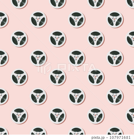 Seamless pattern of white reels for tape recorder isolated on pink background. 107971681