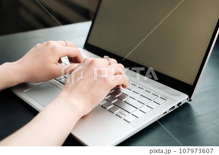 Productive Workspace. Woman's Hands Typing on Laptop Keyboard, Balancing Work and Learning at Office 107973607