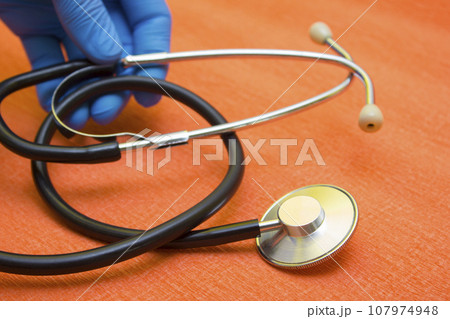 Hands medical gloves hold stethoscope - protection during quarantine, coronavirus, covid19 Hands medical gloves hold stethoscope - protection during quarantine, coronavirus, covid19 107974948