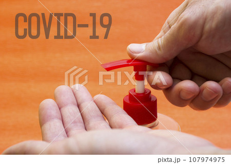 Hands liquid soap dispenser, alcohol-based antiseptics - washing, coronavirus, lettering covid19 107974975
