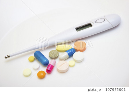 Electronic thermometer with tablets and capsules - protection quarantine, coronavirus, covid19 Electronic thermometer with tablets and capsules - protection quarantine, coronavirus, covid19 107975001