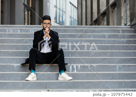Unhappy sad Indian business man frustrated stress pensive feeling bad after company unemployment Unhappy sad Indian business man frustrated stress pensive feeling bad after company unemployment 107975442