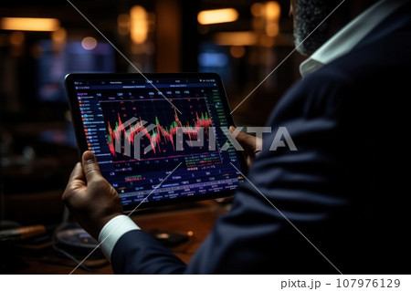 Close up of a trader's hand executing trades on a tablet with market analysis. Generative AI 107976129