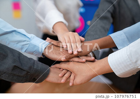 Office worker's hand stack shows solidarity in workplace. Concord Office worker's hand stack shows solidarity in workplace. Concord 107976751