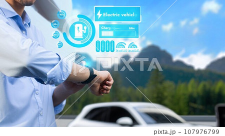 Businessman checking EV car digital battery status in hologram, Peruse Businessman checking EV car digital battery status in hologram, Peruse 107976799