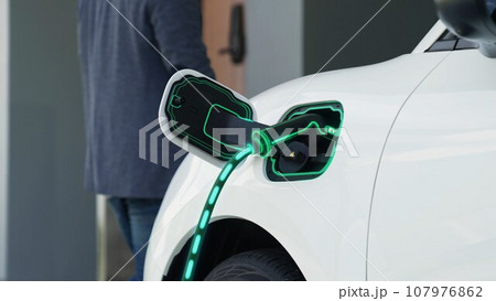 EV charger from home charging station plugged in EV car. Peruse 107976862