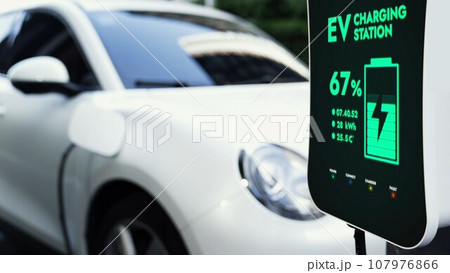 Electric car connected to charging station at public car park Peruse Electric car connected to charging station at public car park Peruse 107976866