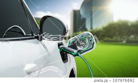 Electric car plugged in with charging station to recharge battery. Peruse Electric car plugged in with charging station to recharge battery. Peruse 107976892