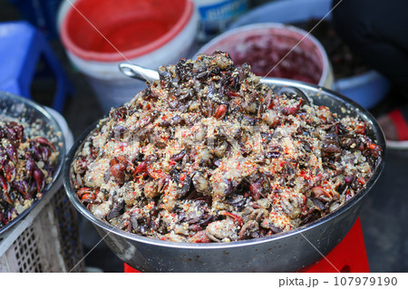 Closeup of Vietnamese fermented fiddler crab sauce and chili in the Bowl for sale in Chau Doc Market, An Giang Province 107979190
