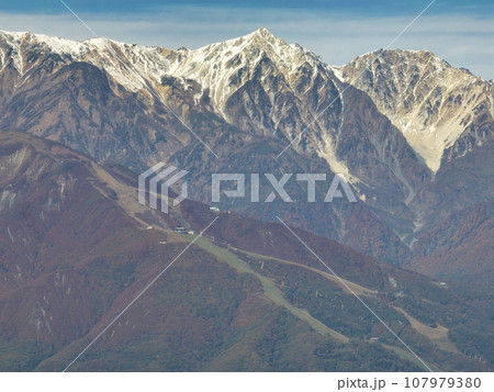 白沢峠からみる冠雪した杓子岳・白馬鑓ヶ岳との三段紅葉　長野県白馬村（ドローンによる空撮） 107979380