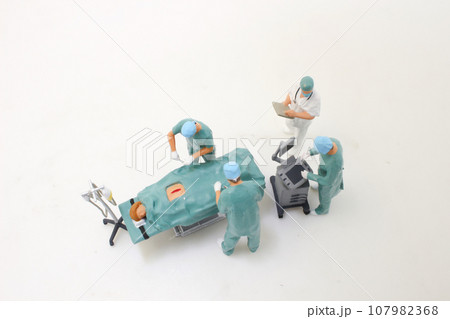 a doctor in cutting thread with scissors, teamwork and support 107982368