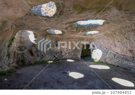 Ancient cave city. Inside the cave, view from the window. Ancient cave city. Inside the cave, view from the window. 107984852