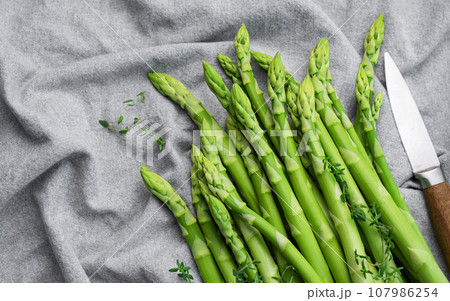 Fresh green asparagus on textile background. Fresh green asparagus on textile background. 107986254