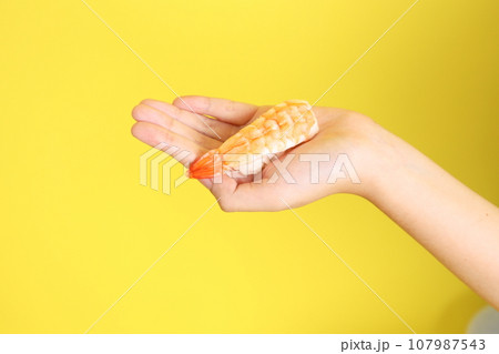 Hand with Sushi 107987543