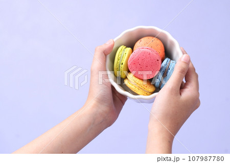 Hand with Macaroons 107987780