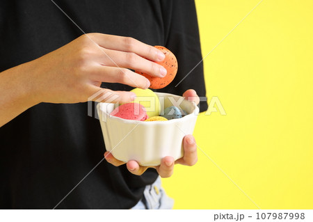 Hand with Macaroons Hand with Macaroons 107987998