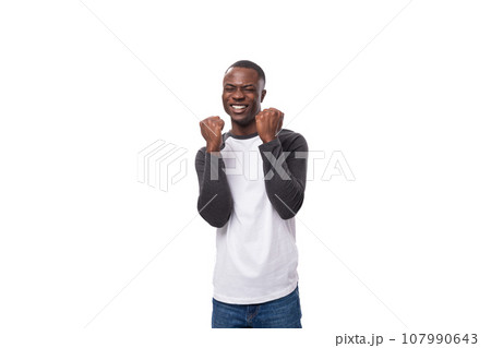 a young american guy with a short haircut feels joy and positivity on a white background with copy 107990643